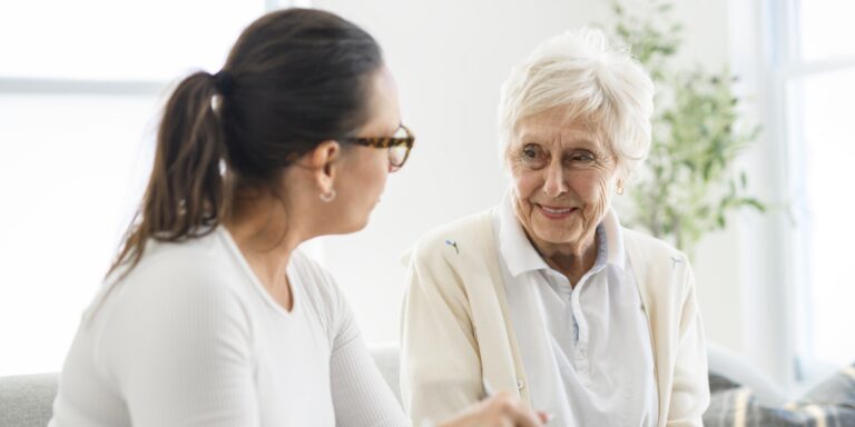supporting elders living at home - care partner and elder woman talking